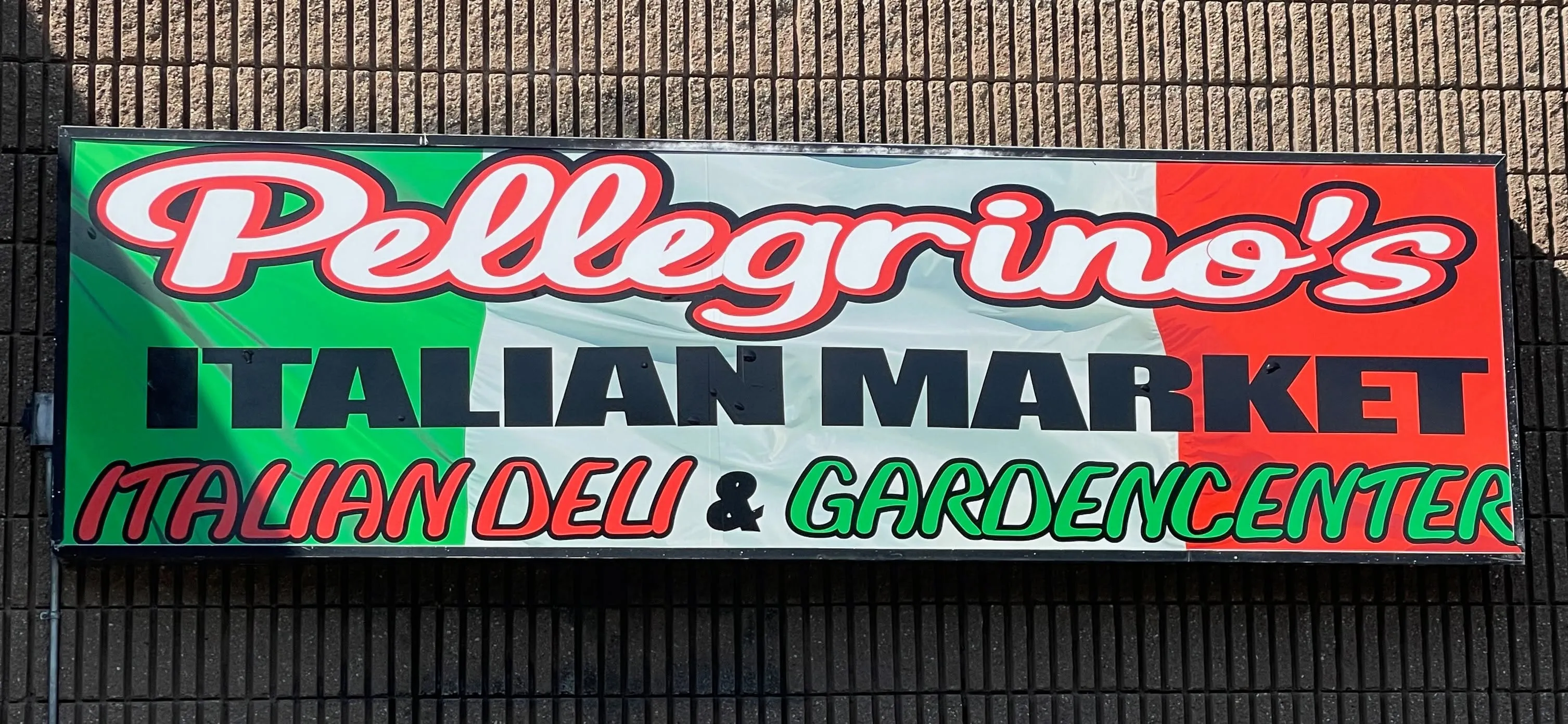 The green, white, and red Pellegrino's Italian Market sign